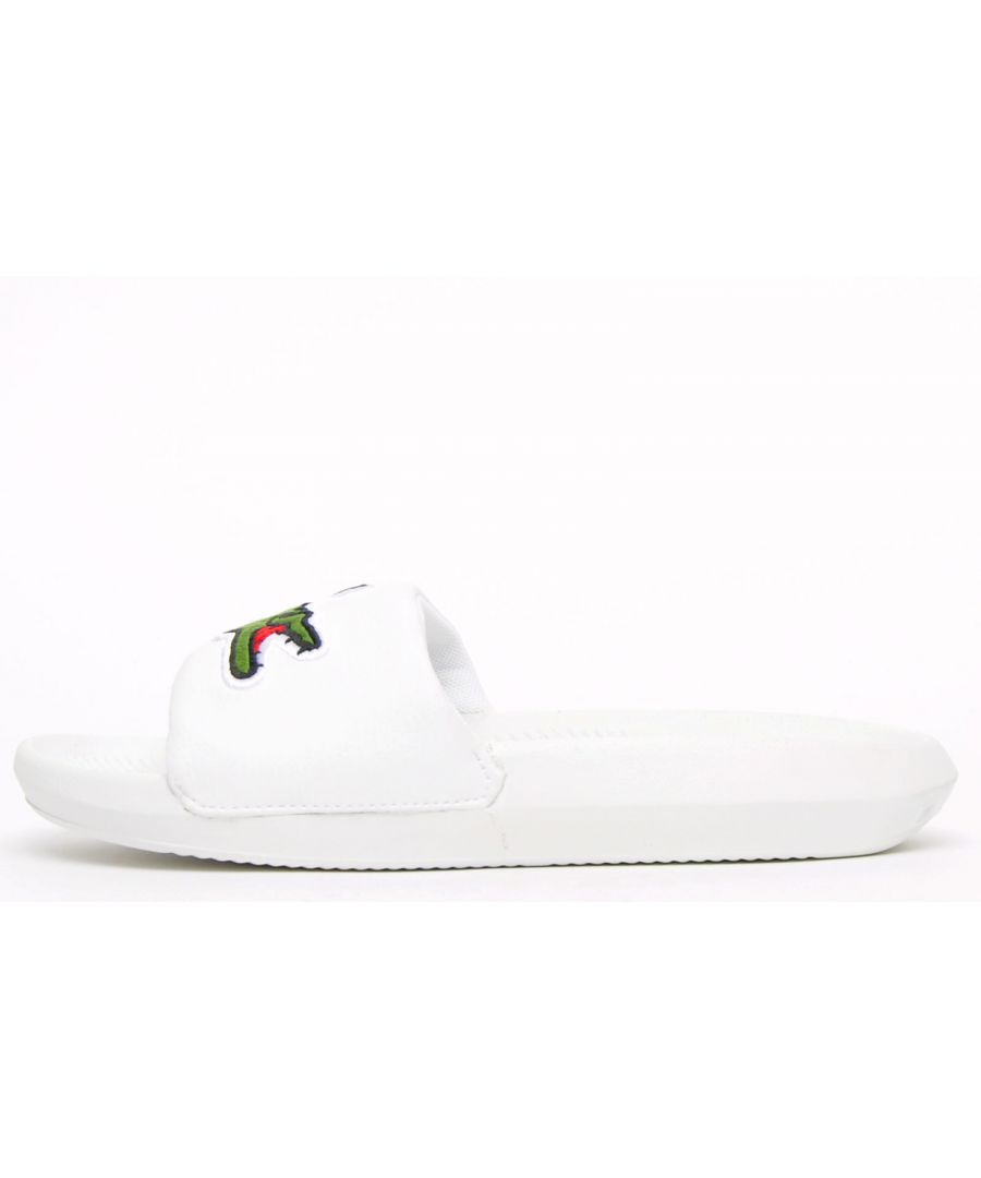 Get into chic on trend style with these Lacoste Croco Slides. These on-trend white sandals are crafted with comfort in mind. The sandal also has a comfort fit cushioned strap and a great water resistant super comfy footbed for a great fit and feel for the pool side and everyday wear. Finished will the iconic croc to the strap for brand recognition.\n Please Note: These sandals are polybagged\n - Comfort fit strap\n - Durable rubber sole\n - Luxurious cushioned footbed\n - Lacoste branding throughout\n Please Note These Lacoste sandals are being sold at a reduced price as they may have minor imperfections which could be any or none of the following; shading issues, small glue marks, dirty marks consistent with the shoes being handled. These are only cosmetic issues and will not affect the overall performance of the slides and after a few wears any marks may become less noticeable. However, if you are unhappy with your purchase we will be more than happy to take the shoes back from you and issue a full refund.