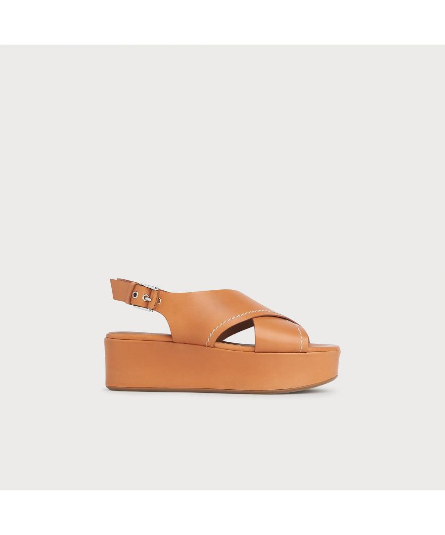 A contemporary take on a classic shape, our Sima slingbacks have an easy-to-wear flatform sole. Crafted in Italy from vegetable-dyed tan leather which is known for its high quality, they're dyed using natural materials, less chemicals, and aren't coated or covered, so you can see the beauty in the leather. They have a crossover front with contrast stitching detail, a silver-tone buckle slingback and a leather-covered 55mm flatform sole.