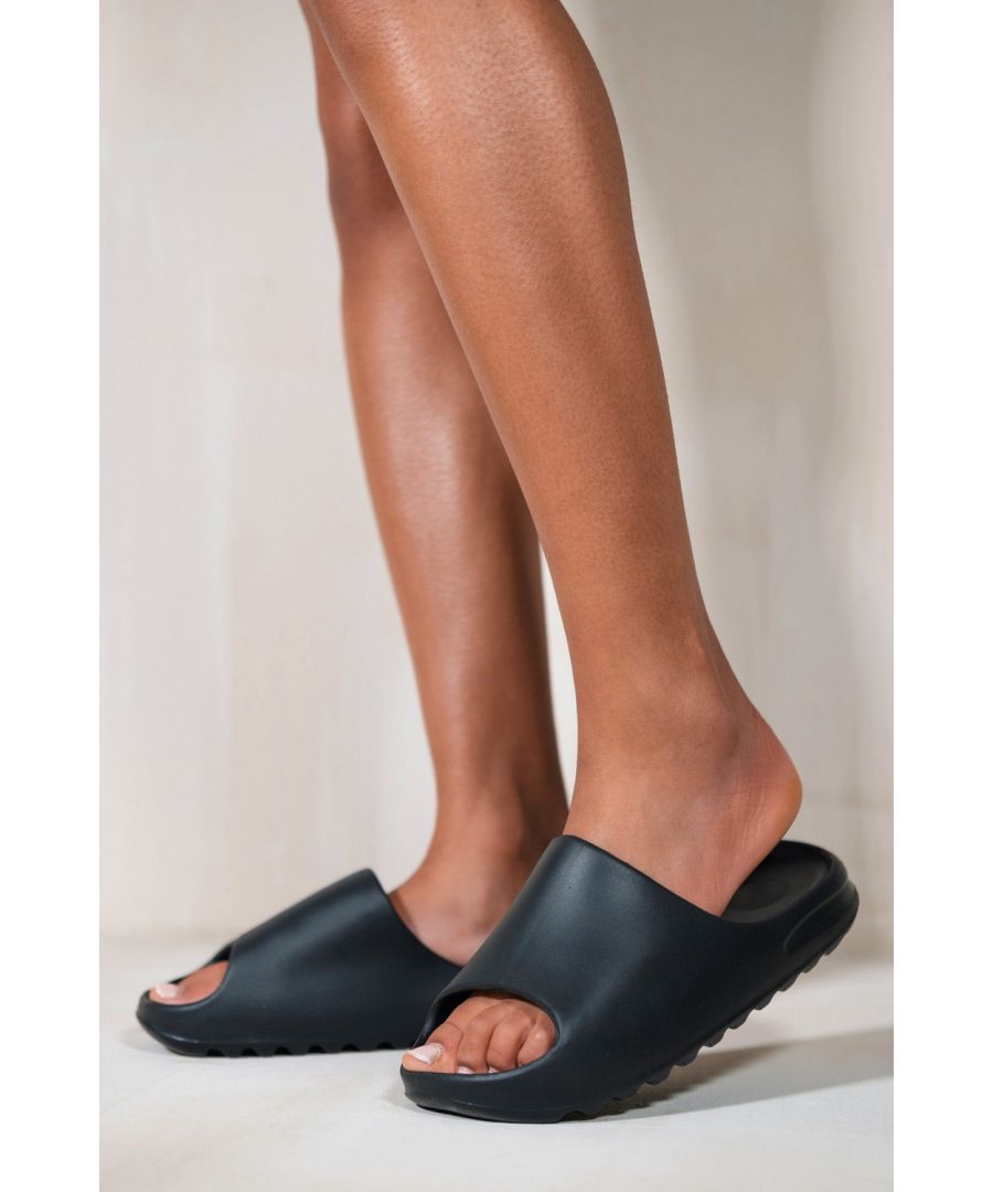Women's sliders featuring a flat rubber sole.