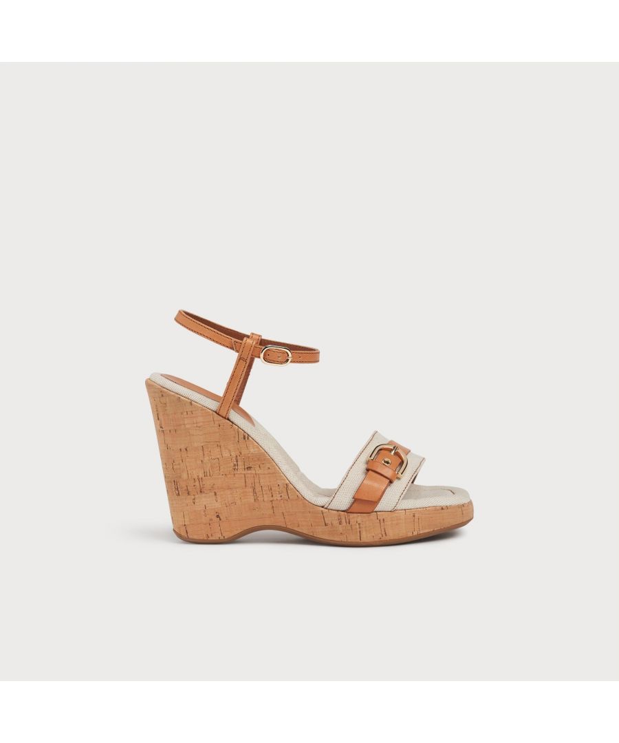 Taking on canvas and leather, one of our key fabric combinations for the summer season, our Sky wedges are all about texture. They're crafted in Italy from natural canvas and vegetable-dyed tan leather, known for its high quality and dyed using natural materials, less chemicals and not coated or covered, so you can see the beauty of the leather. They have a single strap over the toes with gold-tone buckle detail, a delicate ankle strap and a cork wedge 110mm sole.