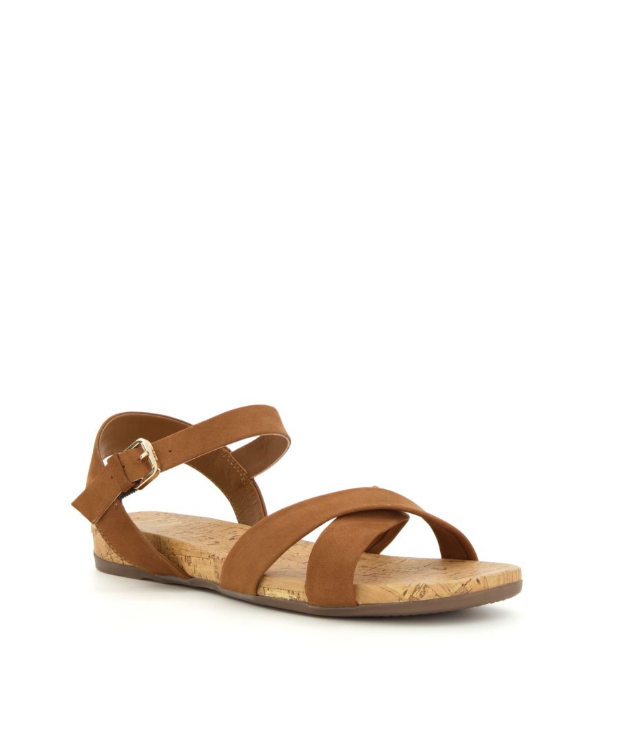 Step out in comfort and style with Lorrie. Crafted with the finest materials, these timeless flat sandals boast an ergonomic corkscrew footbed and cross-strap upper.