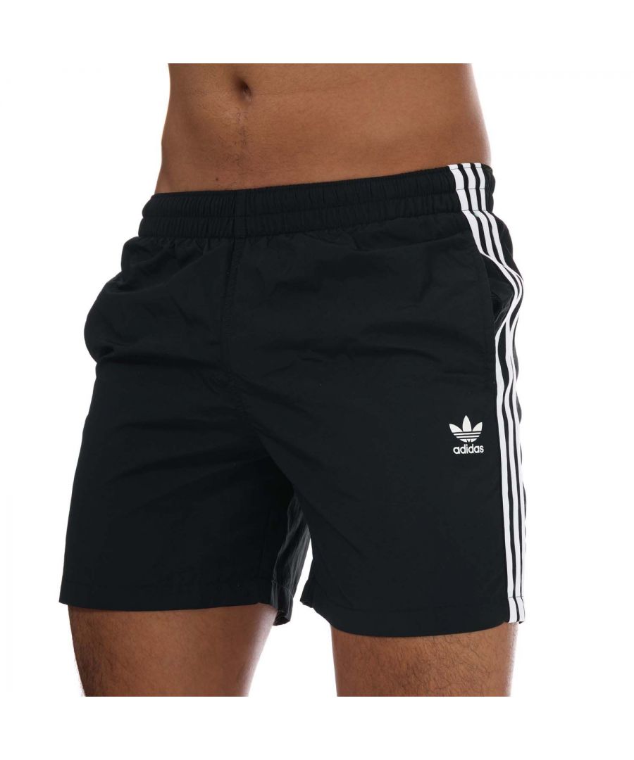 Mens adidas Originals Adicolor Classics 3- Stripes Swim Shorts in black.- Drawcord on elastic waist.- Side pockets.- Mesh lining.- Regular fit.- Shell: 100% Polyamid (Recycled). Inner Brief: 100% Polyester (Recycled). - Ref: GN3523