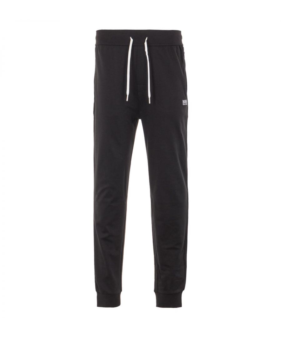 Perfect for downtime styling with a sporty feel, these tracksuit bottoms from BOSS are crafted from super breathable cotton blend knitted pique. Featuring an adjustable drawstring waist, twin side seam pockets, ribbed ankle cuffs and contrast piping down the seams adding to the sporty look. Finished with the iconic BOSS logo embroidered at the left leg. Regular Fit, Cotton Blend Knitted Pique, Adjustable Drawstring Waist, Twin Side Seam Pockets , Ribbed Ankle Cuffs, Contrast Piping, BOSS Branding. Style & Fit: Regular Fit, Fits True To Size. Composition & Care: 70% Cotton, 30% Polyester, Machine Wash.