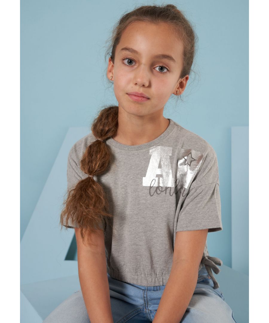 A super soft cotton jersey tee with rib neckline. A gentle gathered waist with tie detail  shorter length  droped shoulder and foil logo it's a fashion staple.    Angel & Rocket cares - made with Fairtrade cotton   Colour: Grey Marl   100% Cotton   Look after me – Think planet  wash at 30c