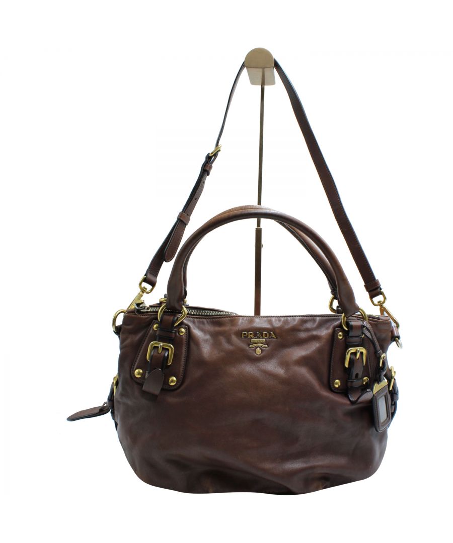 VINTAGE, RRP AS NEW\nThe Prada Nocciolo Soft Calf Leather Satchel Bag is as versatile as it is stylish. The adjustable leather strap is also detachable so the bag can be worn as a cross body or removed all together. The rich brown color is anything but basic with the gold-tone hardware and leather detailing. Don't miss out on this functional and fashionable handbag sure to be a staple in your wardrobe. \n\nA bag that can carry by hand and wear cross body. \n\n\nPrada Nocciolo Satchel Bag in Brown Calf Leather \nColor: brown\nMaterial: Leather | Calfskin leather\nSize: one size\nCondition: very good\nSign of wear: Yes\nSKU: 125428 / TONBKGBBA118751W  \nDimensions:  Length: 380 mm, Width: 170 mm, Height: 280 mm