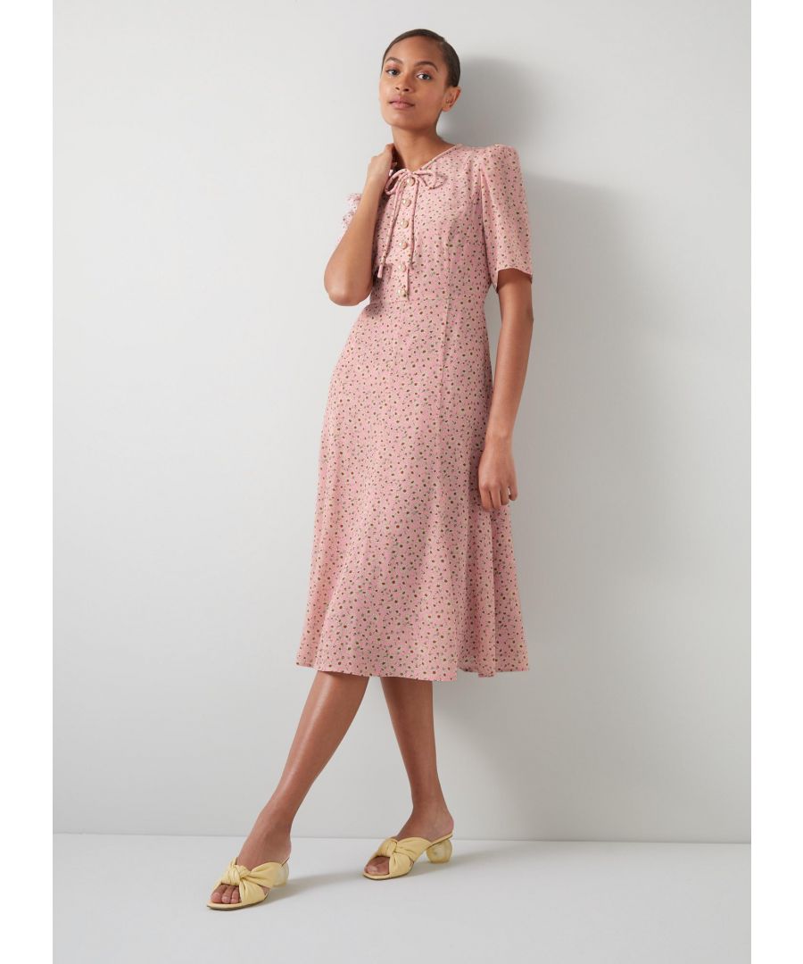 Re-worked for the new season, our bestselling Montana dress is a welcome nod to spring with its 1960's daisy print reimagined from vintage archives in pink, white and red. Cut to the much-loved tea dress shape, this midi-length, short-sleeved style is crafted from pure silk with oversized pearl buttons and tie detail to the collar - adding a vintage touch to this modern design. Wear it with a playful platform shoe for spring occasions.