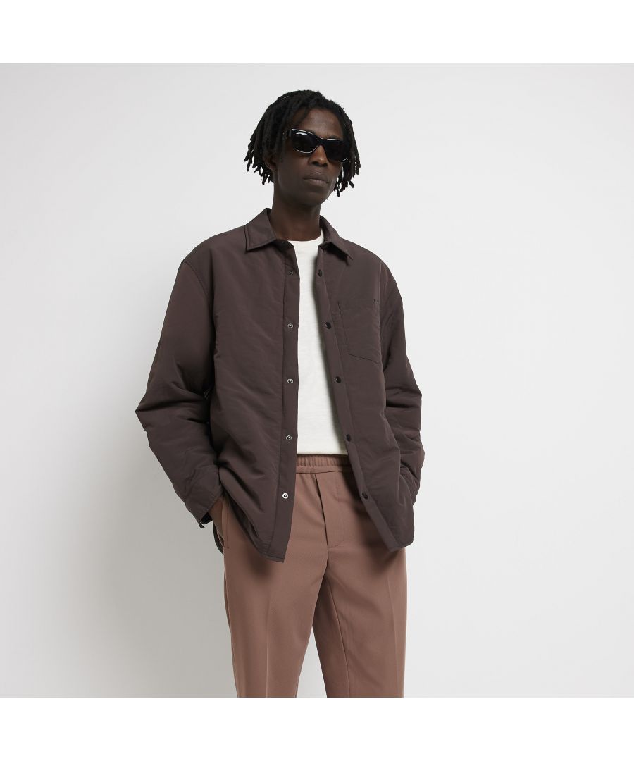 > Brand: River Island> Department: Men> Colour: Brown> Type: Button-Up> Size Type: Regular> Fit: Regular> Material Composition: 100% Nylon (polyamide)> Occasion: Casual> Closure: Button> Material: Nylon> Neckline: Collared> Sleeve Length: Long Sleeve> Season: SS22
