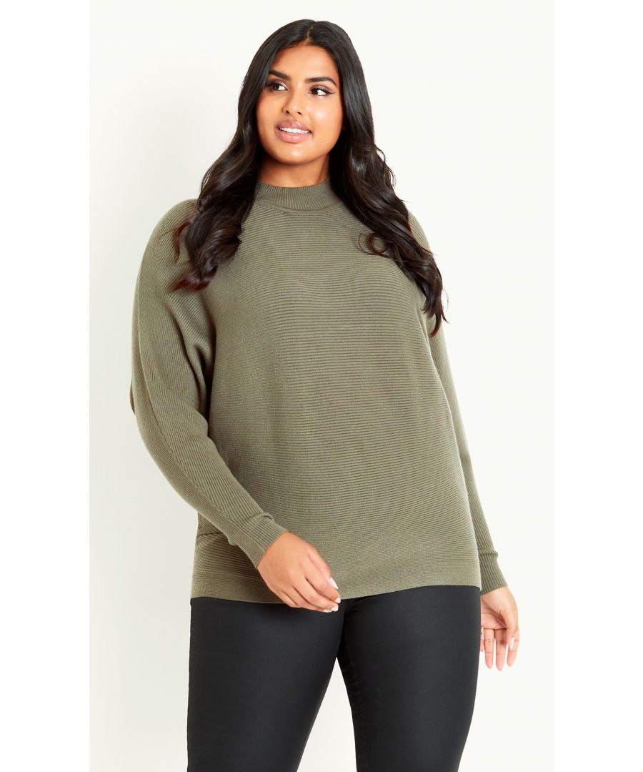Add to any look with the relaxed fit and ribbed knit texture of the Janie Ribbed Sweater. The dolman sleeves and high neckline add versatility and style to this must-have layering piece, in a fashion-forward olive green. Key Features Include: - High mock neckline - Long batwing sleeves - Relaxed fit - Textured knit fabrication - Hip length hemline