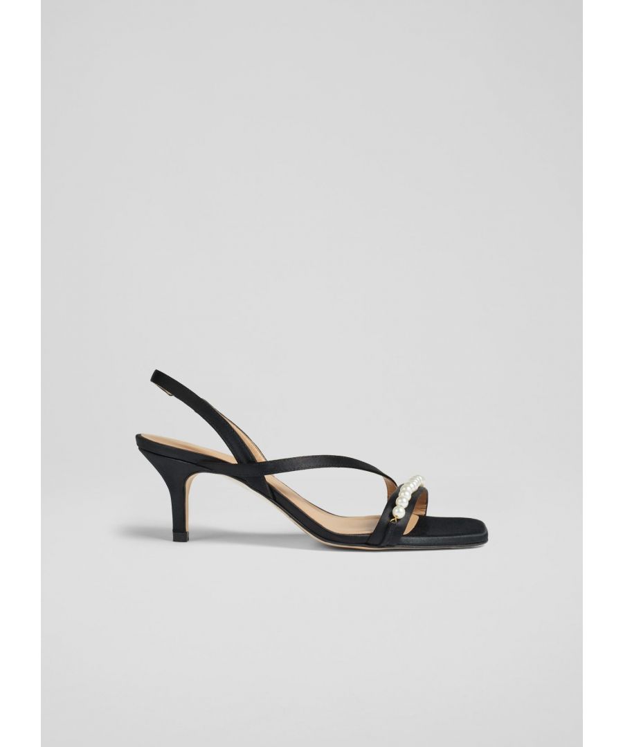 We’ve given the classic strappy sandal a contemporary upgrade in time for party season with Greta. Featuring a fun pearl design across the strap, they are the perfect pair when you want to feel dressed up. Crafted in Spain from black satin fabric, they have a single strap over the toes, one across the foot, an elasticated slingback and a 60mm stiletto heel.