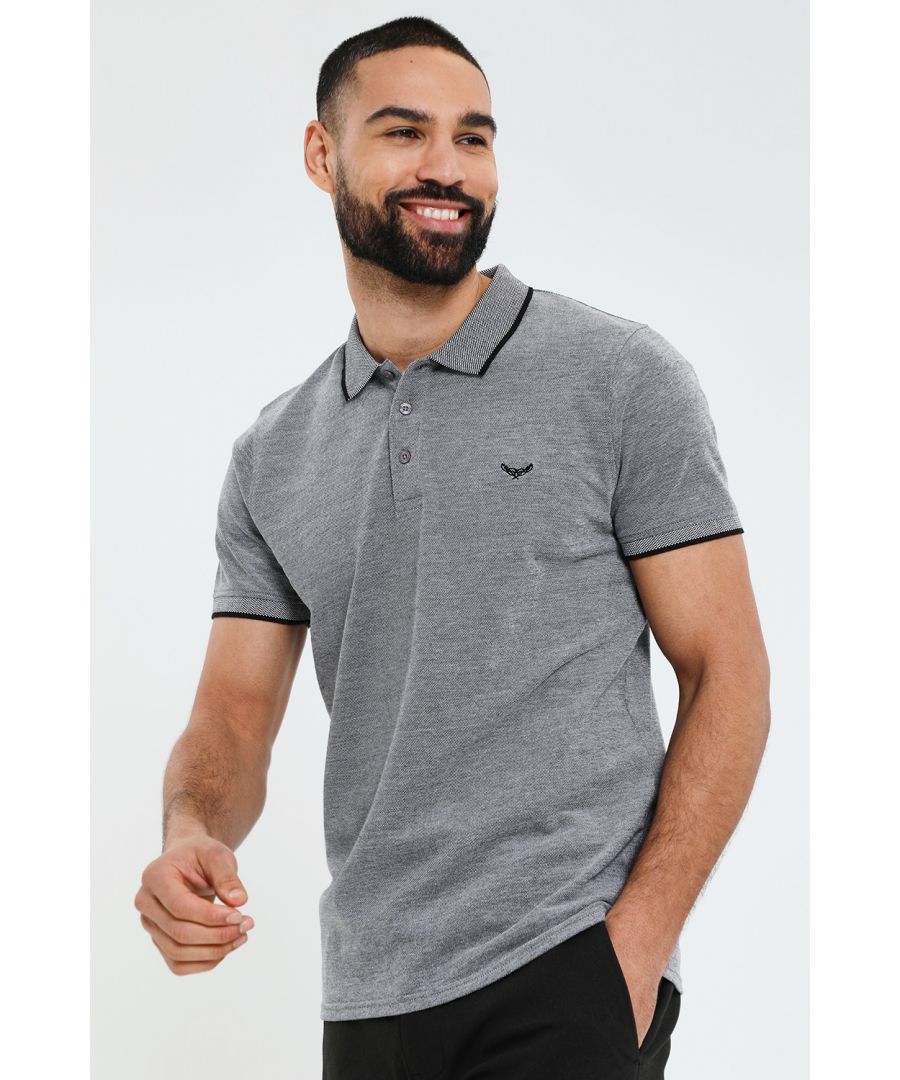 Style up your everyday wear with this pique polo shirt from Threadbare. Cut in a regular fit, this short sleeve polo shirt has a traditional collar with white tipping, placket with branded buttons, and set in sleeves with ribbed cuffs with white tipping. Finished with Threadbare embroidery on the chest, and classic woven Threadbare branded tab above the hem. Team with jeans, chinos or shorts for a laidback luxe look that's perfect for smart casual outings and everyday wear.