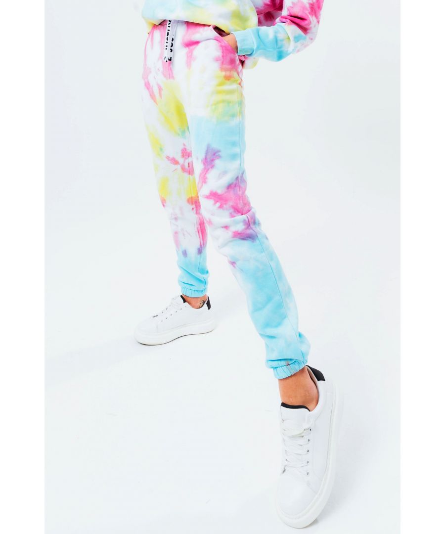 The HYPE. Tie Dye Drawstring Women's Joggers are perfectly matched with the HYPE. oversized tie dye crew to complete the look. Or opt for a cute contrasting white body suit for a day to night feel. Designed in 80% cotton and 20% polyester for supreme comfort. The design features an all-over tie-dye inspired print in a red, yellow and blue colour palette. With an elasticated waistband and woven embossed drawstrings, these essential joggers are the perfect addition to your jogger 'drobe. Machine wash at 30 degrees.