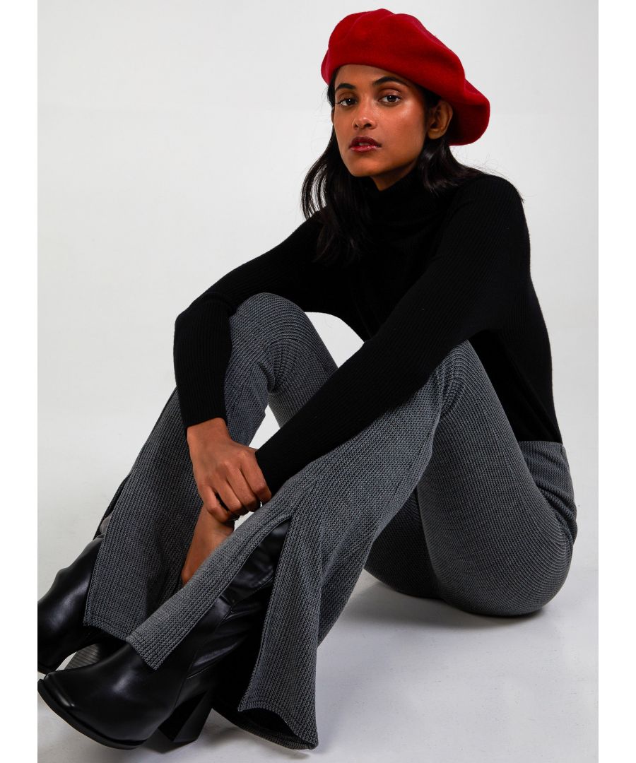 Feel the flare this season with our knitted front split trousers, feel super cosy yet super hot and stylish in one simple move! Composition: 95% Polyester, 5% Elastane. Wash care: Machine Washable