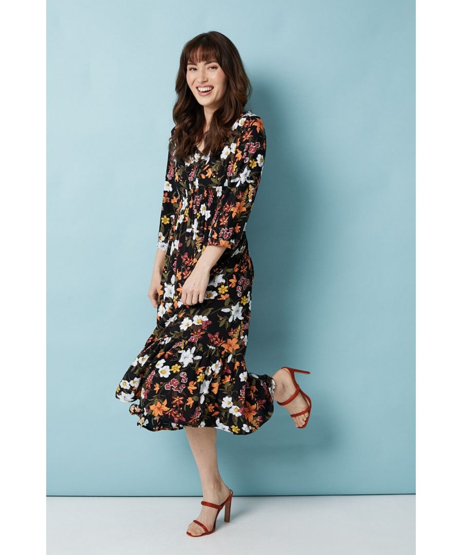 Stand out from the crowd in this floral printed midi dress. With a v-neck button front, 3/4 length sleeves, a cinched waist and a tiered full midi skirt. Pair with nude heels for a smart casual look to take you from day to night.