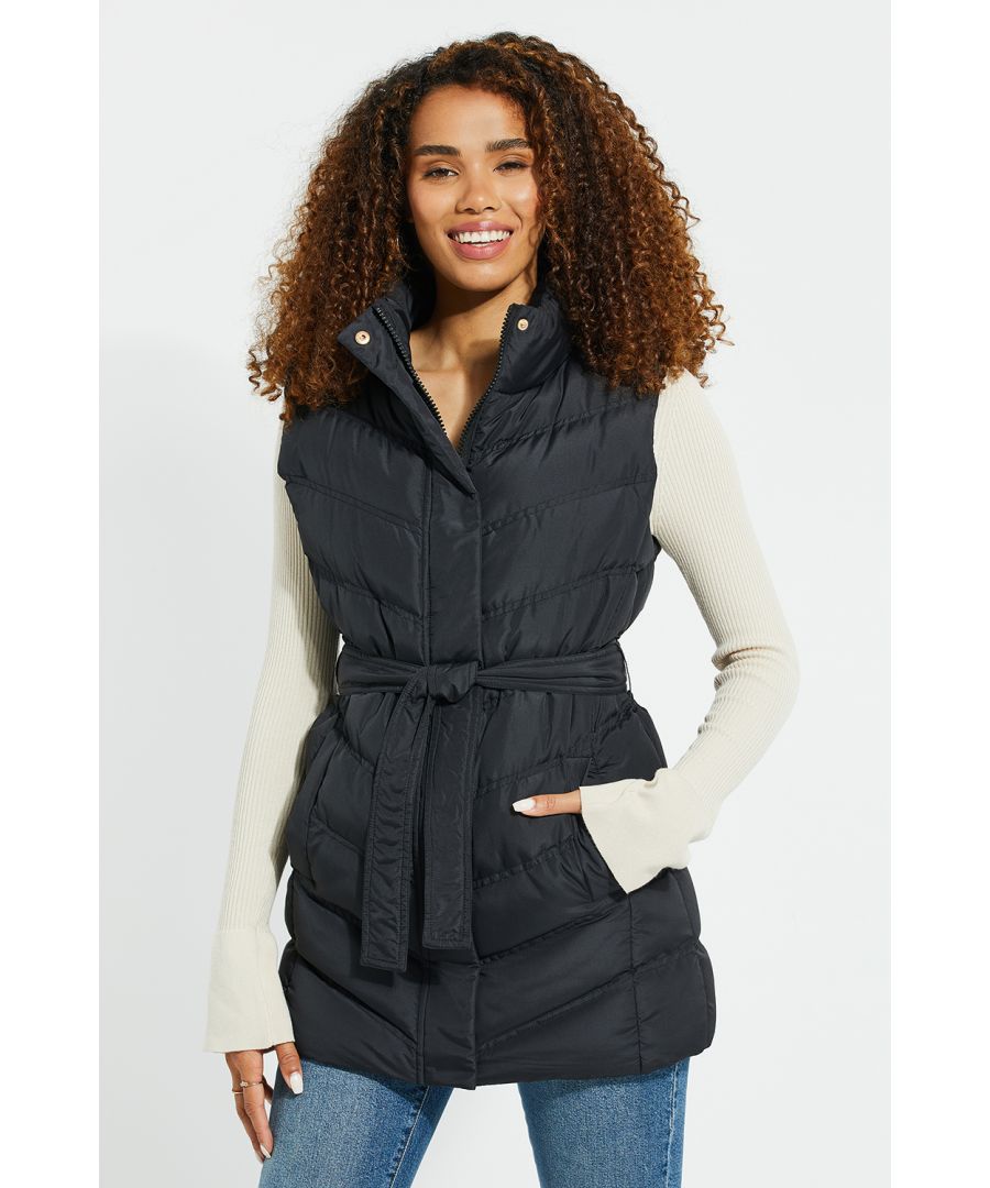 Add an extra layer of style with this longline, padded gilet from Threadbare. This gilet has padding for extra warmth, two open pockets, and zip and snap fastenings. It is also styled with a self-tie waist. Other colours and similar styles are available.
