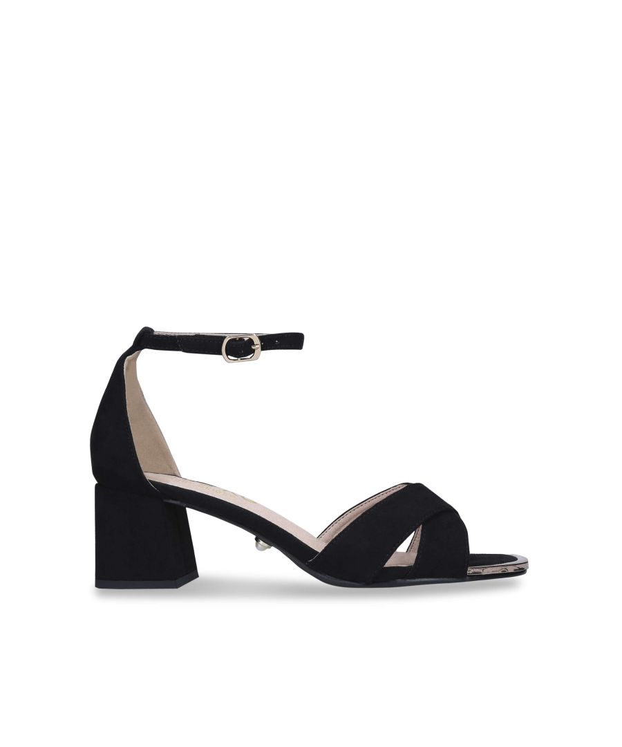 The black Gabi heels feature a block heel and buckled ankle strap. The straps across the toe are crossed with a gold tip to the toe. 5.5cm heel. Pearl stud on the outer sole.