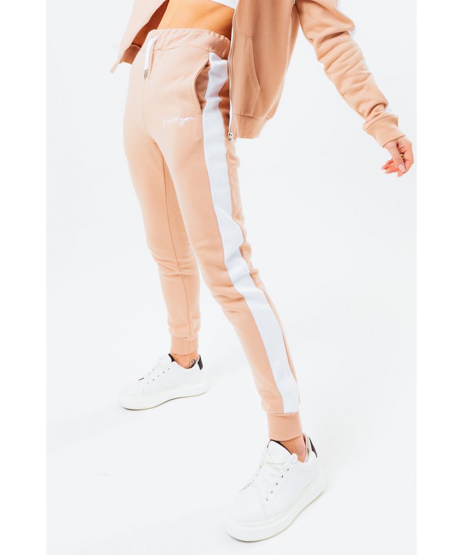 Joggers versatile for every occasion. The HYPE. Chestnut Women's Signature Joggers, available in UK size 4 up to 18, designed in 80% Cotton and 20% Polyester - the ultimate amount of comfort, room and breathable space you need. In our standard women's jogger shape, with on trend contrasting leg panelling, an elasticated waistband, fitted cuffs and drawstring pullers. Finished with the new! justhype scribble logo. Check out the matching women's hoodies and t-shirts in the scribble range, perfect to mix 'n' match your day to night looks. Machine wash at 30 degrees.
