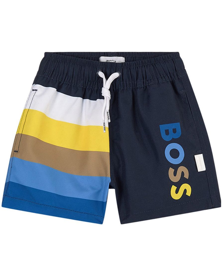 These Hugo Boss Baby Boys Swim Shorts in Black are crafted from silky, soft and lightweight material and have colourful stripes and logo on the legs. It features side seam pockets and an elasticated waistband with adjustable white drawstring ties.\n\nSilky, soft & lightweight material\nColourful stripes\nSide seam pockets\nAdjustable drawstring ties