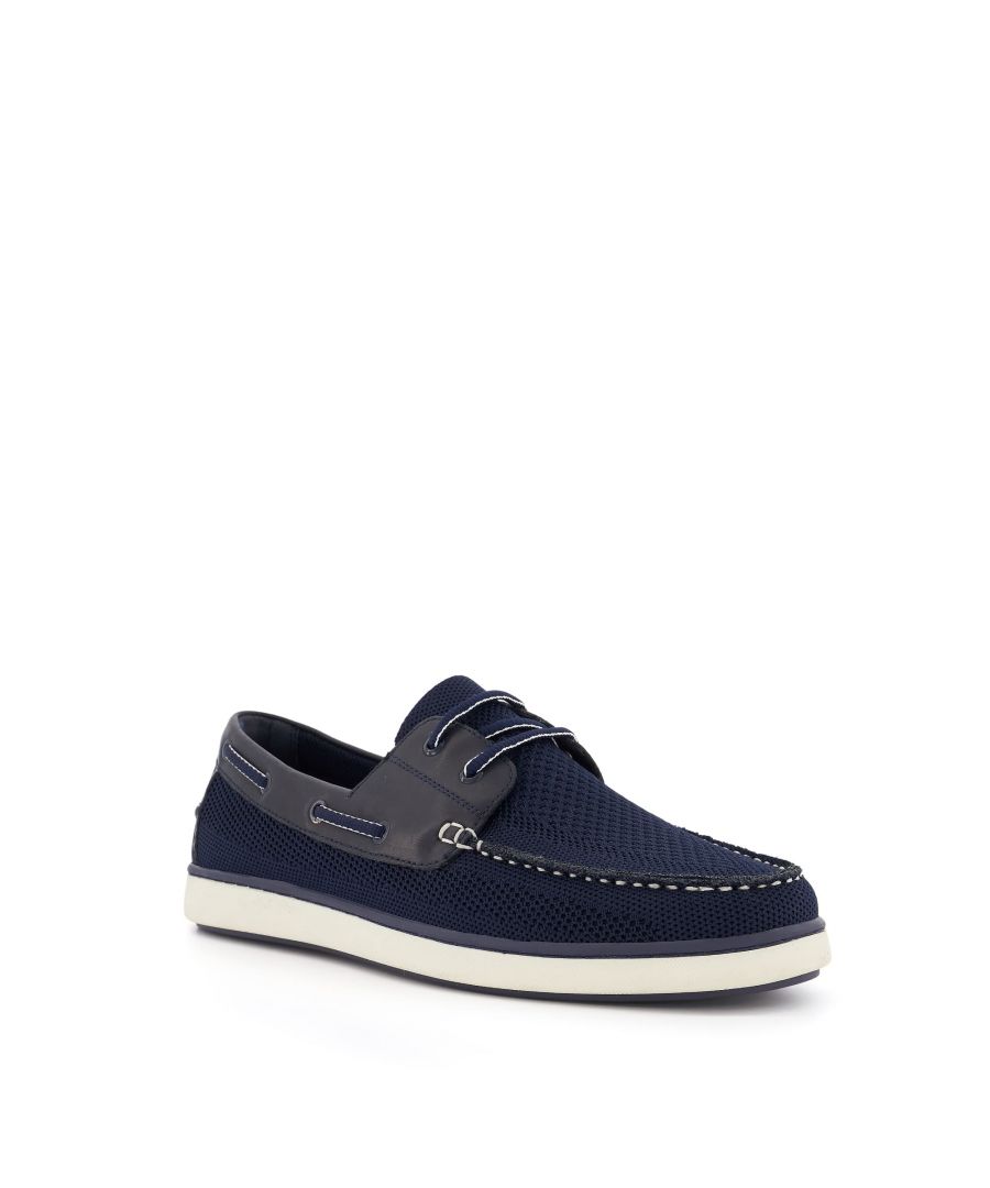Defined by the laces that traverse the heel, originally to prevent them from flying off the deck in high winds, the timeless boat shoe is a warm-weather must-have.