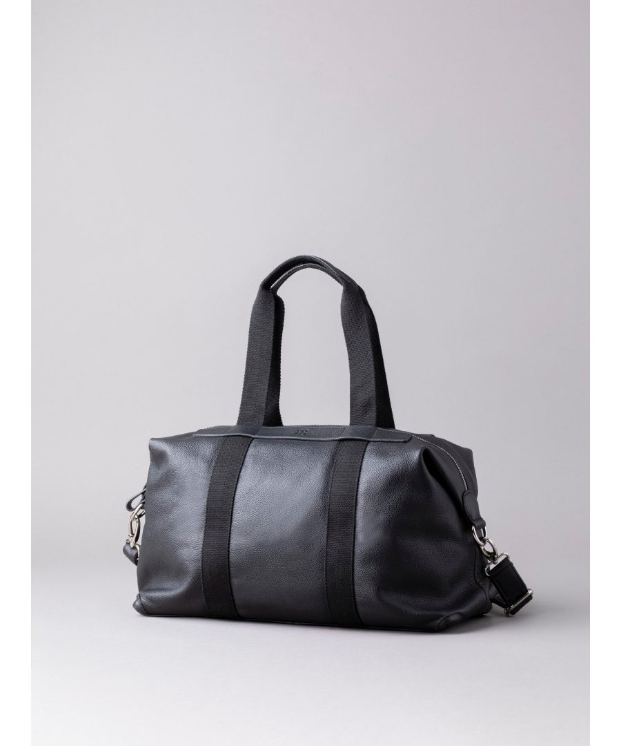 The Lorton Medium Leather Holdall in black is the perfect travel companion for your next trip away. Crafted in luxurious leather, its features include shoulder straps and an adjustable and detachable canvas strap for multiple ways to carry, and magnetic side studs to make your holdall more neat and compact once filled. The spacious interior lined with soft fabric contains handy zip and slip pockets to store your smaller valuables and the exterior features a rear zip pocket for quick access essentials.