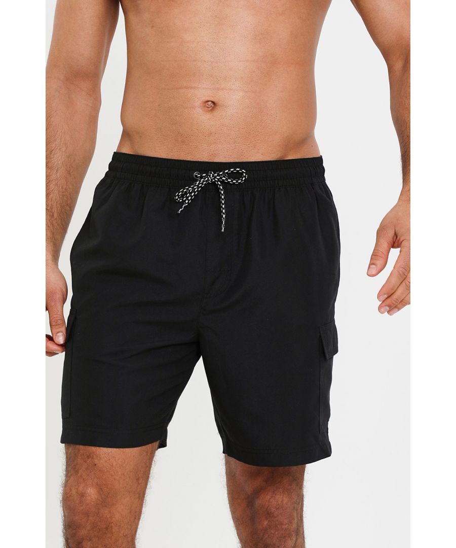 Ideal for holidays, these swim shorts from Threadbare are designed in a cargo short style for that relaxed holiday vibe. With cargo pockets to the sides of the legs, these swim shorts are made from 100% recycled polyester and have an inner mesh lining for comfort and support when swimming. They feature an elasticated waistband with eyelets and drawcords for that desirable sporty finish, along with two side entry pockets, and a welt back pocket with a touch and close fastening. Perfect for the summer months chilling by the pool. They can be paired with a simple tee or vest when out of the water for casual dressing.