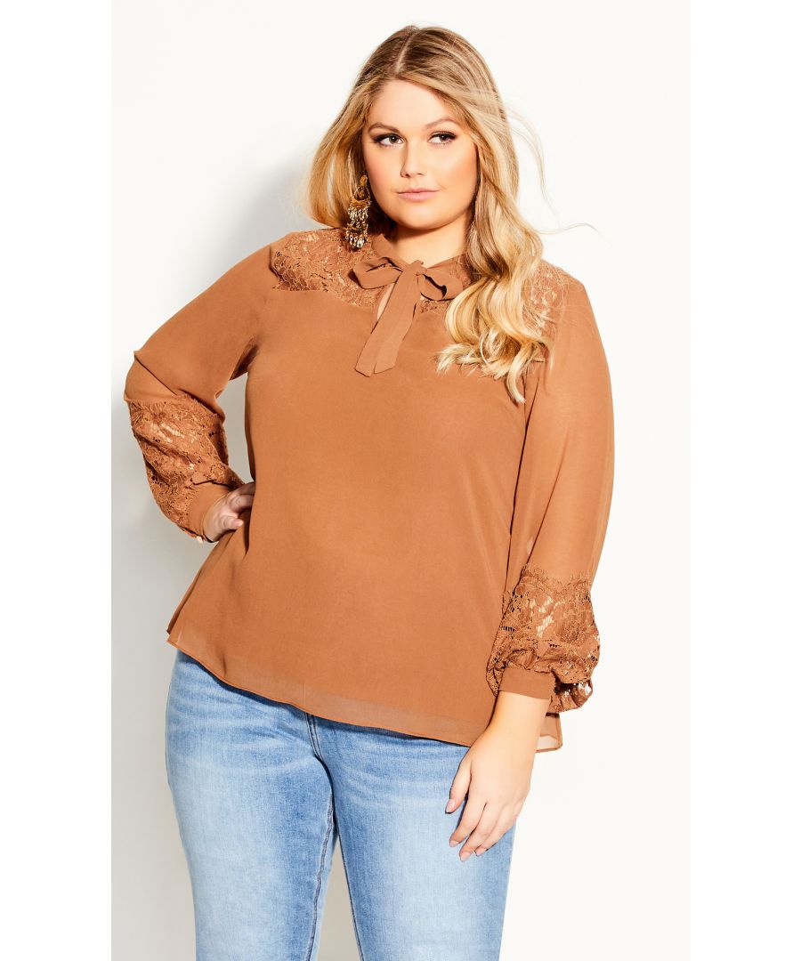 Step up your office attire with the addition of the Mysterious Lace Top to your repertoire. Featuring a flirty bow tie neckline, dreamy puff sleeves and delicate lace inserts, this gorgeous blouse is a must have for any style-savvy woman. Key Features Include: - V neckline with pussy bow neck tie - Laced front & back yoke - Long sleeves with lace cuff detail - Relaxed fit - Pull over style Style with mid wash denim and blush ballet flats for a flirty look perfect for lunch dates and drinks with the girls!