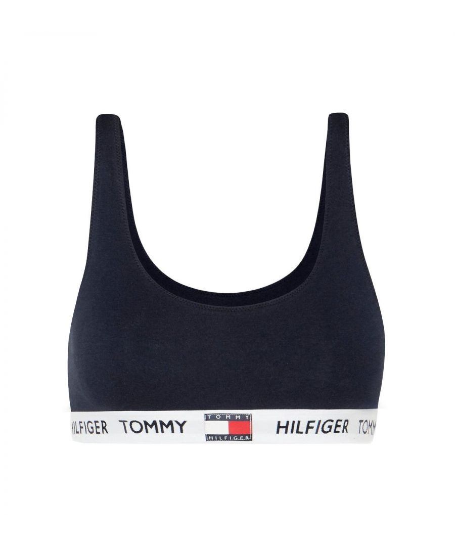 This pull-on bralette from Tommy Hilfiger cries out comfort and versatility. Whether wearing as an undergarment or pulling on with your favourite joggers you are sure to look on point. Crafted from organic stretch cotton with a flattering scoop neckline and printed stretch logo band.\n\nPull-on design\nScoop neck\nStretch organic cotton\nTommy Hilfiger repeat logo under-band\nComposition: 91% Organic cotton | 9% Elastane\nListed in UK sizes
