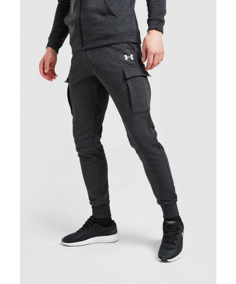 Mens Threadborne Cargo Joggers from Under Armour. Coming in a fresh Black Charcoal colourway, these loose-fit joggers are made with smooth, durable Fleece poly cotton fabric for lightweight, lasting comfort. They feature and elasticated waistband for a snug feel, and tapered legs with ribbed trims for an optimized fit. With side pockets at the waist, they have cargo-style pockets to the legs to elevate the look. Finished up with classic UA branding at the thigh.