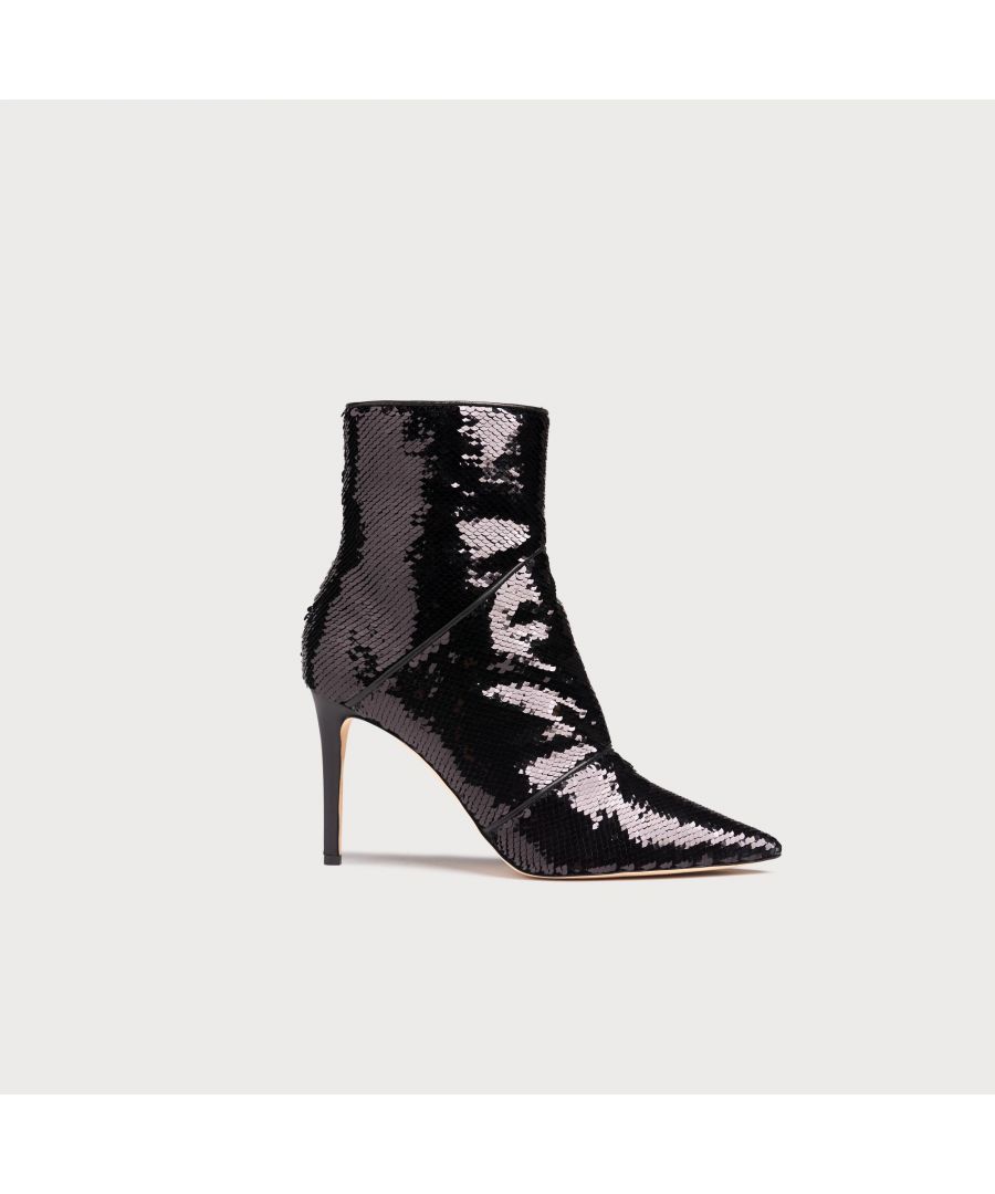 Sharp, sexy and sequinned, ankle boots don't come more glamorous than Veronica. Crafted from sparkling black sequins, these statement boots have pointed toes, stiletto heels and piping detail across the foot. Wear them with tailored trousers to emulate their sleek silhouette or with your favourite party dress over the festive season.