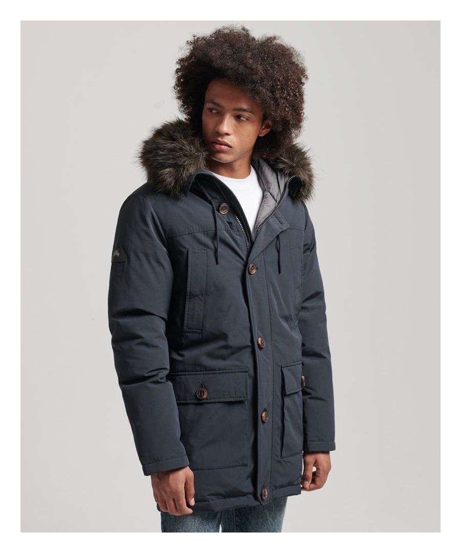 No need to trade functionality for fashion - stay warm the right way. Obsessed with detail, we've ensured that this coat will keep you comfortable and cosy thanks to its down filling, ribbed cuffs, and faux fur hood trim.Relaxed fit – the classic Superdry fit. Not too slim, not too loose, just right. Go for your normal sizeRemovable faux fur hood trimAdjustable drawcord hoodZip and button fasteningTwo-way zip with leather pullersDown and feather fillingLong sleevesRibbed cuffsSix external pocketsInternal breast pocketNylon liningLogo badgeSuperdry is certified by the Responsible Down Standard to confirm that our down filled products are sourced to ensure animal welfare.