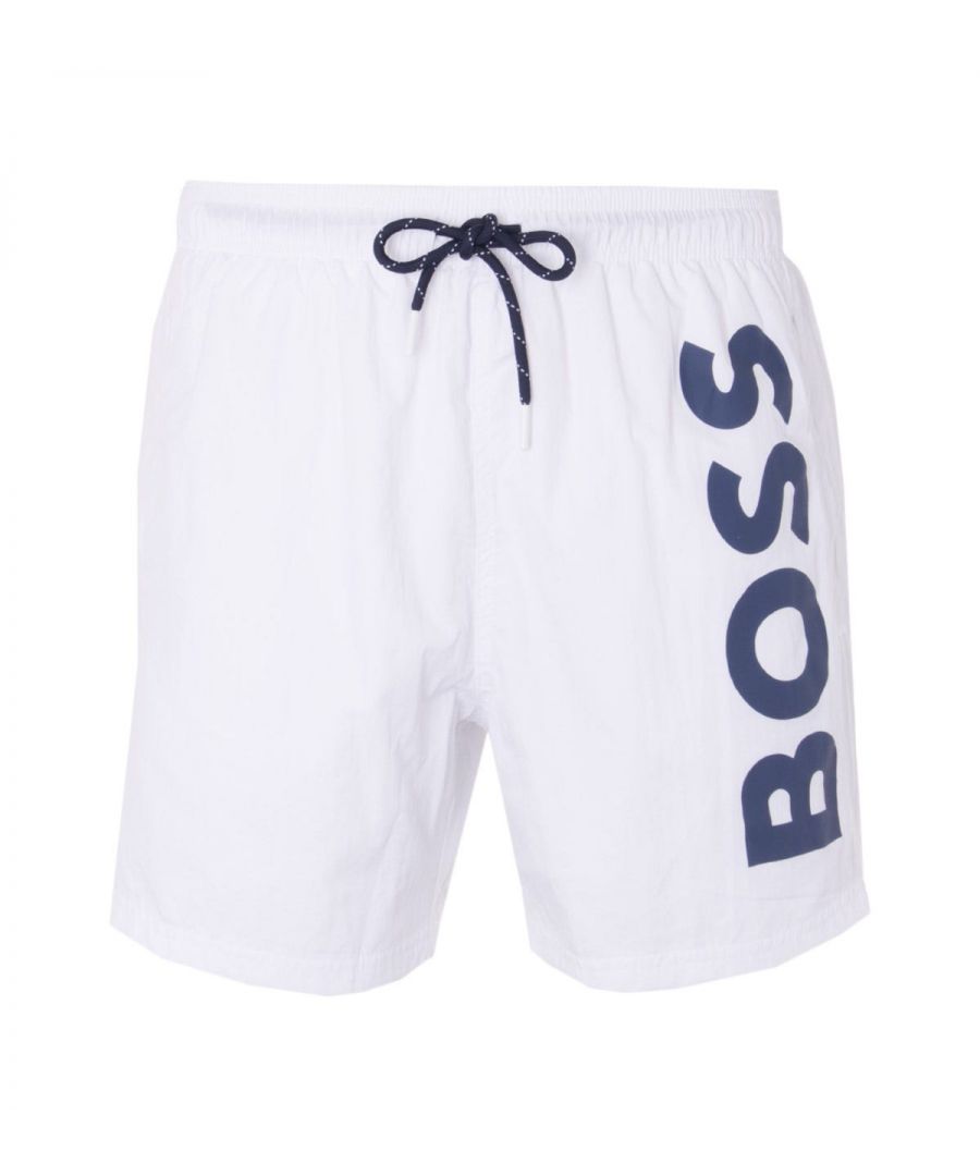 Swim in style this season with BOSS. These sporty swim shorts are crafted from a quick drying nylon fabric with a mesh lining for extra support. Featuring an elasticated drawstring waist, twin side seam pockets and a rear welt pocket. Finished with a large BOSS logo in a contrast print to the left leg. Regular Fit, Quick Dry Nylon, Elasticated Drawstring Waist, Twin Side Seam Pockets, Rear Welt Pocket, BOSS Branding. Style & Fit: Regular Fit, Fits True to Size. Composition & Care: 100% Polyamide, Machine Wash.