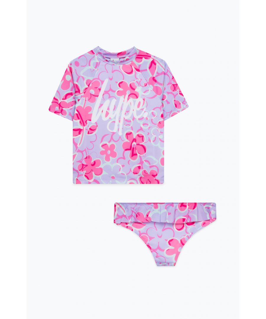 Swim is in. Meet the HYPE. Lilac Floral Script Short Sleeve, the ultimate girls swimwear you'll want to wear everyday of summer, autumn, winter and spring. Featuring a short sleeve top and bottoms in a 80% Poly 20% Elastane blend for ultimate comfort, boasting an all-over floral print in a lilac and pink colour palette and the HYPE. script logo in contrasting white. Wear with HYPE. sliders, swimming goggles and a beach towel in hand. Machine wash at 30 degrees.