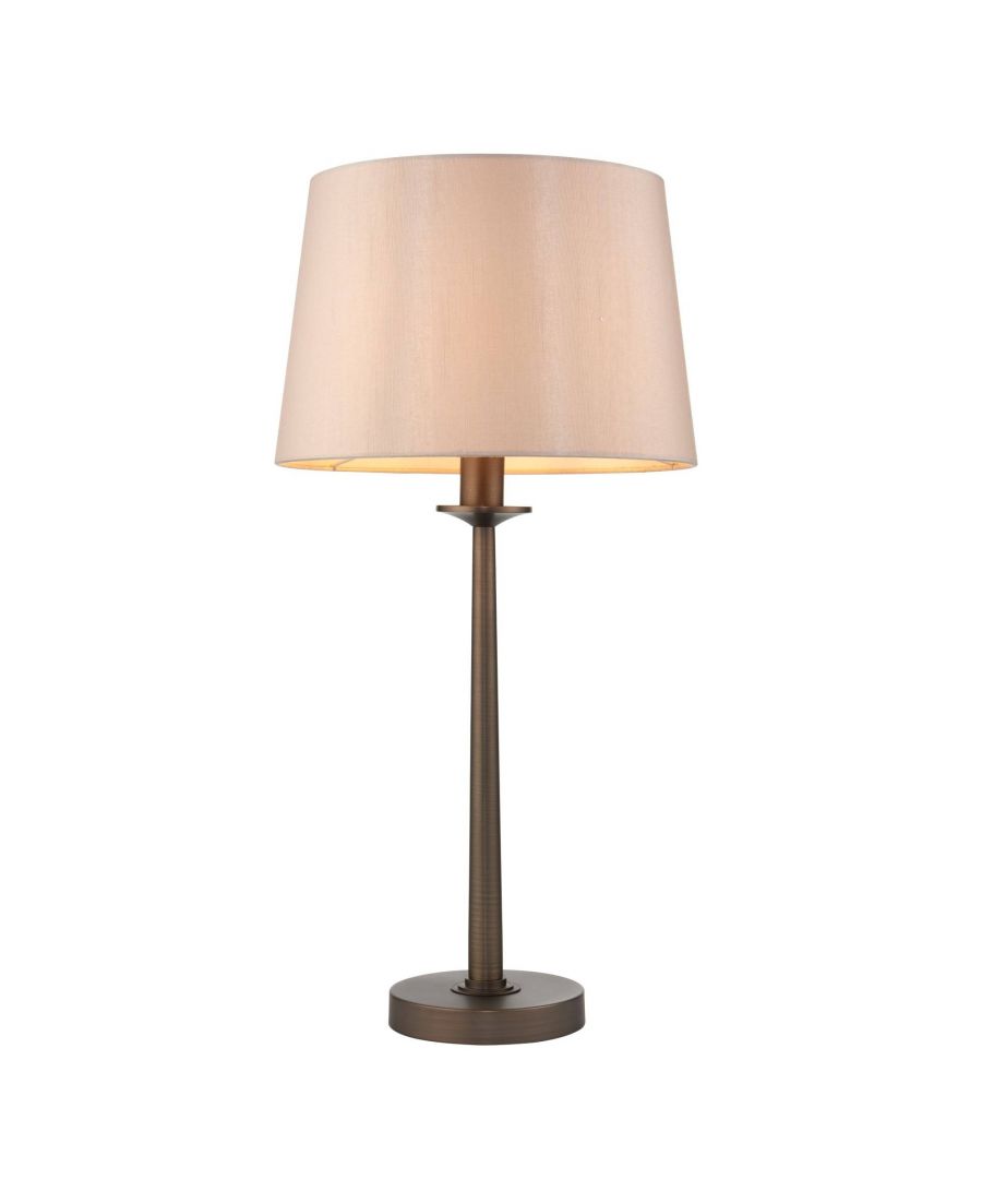 Modern table lamp boasting a dark antique brass base and champagne shade.  Height: 59.5cm  Diameter: 30cm  Maximum Wattage: 40w  Light Bulb: 1 x E27 Light Bulb (Not Included) A modern take on a traditional style table lamp, the Irvine Table Lamp is a stylish Pagazzi Exclusive. Boasting a slim, dark antique brass base, this minimal table lamp is finished with a luxurious faux silk champagne shade. Suitable for both traditional and modern interior decor, this table lamp would look great as bedside tables, in hallways or living areas.