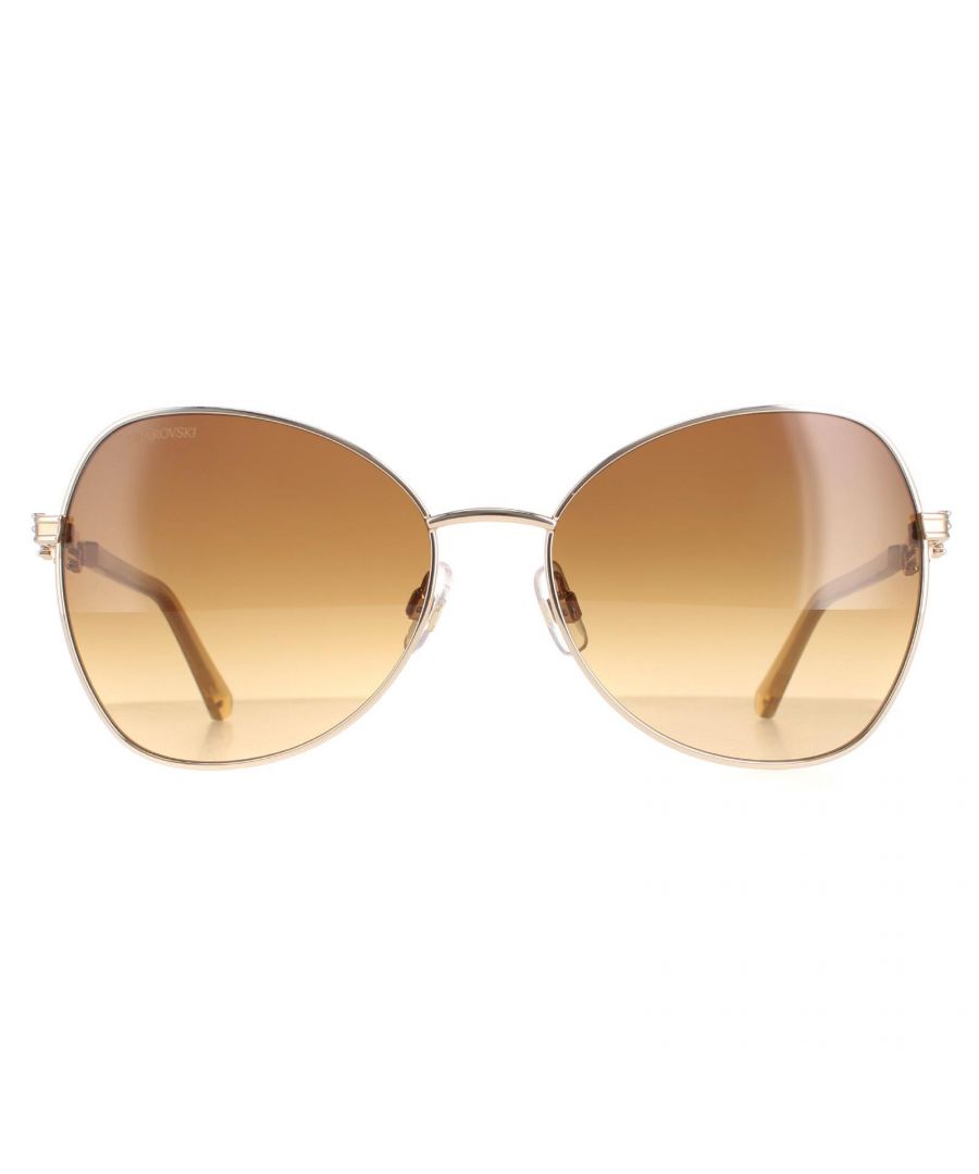 Swarovski Butterfly Womens Shiny Gold  Brown Gradient SK0290  Sunglasses are a glamorous butterfly design crafted from lightweight metal. Silicone nose pads and plastic temple tips ensure all day comfort. The slender temples are embellished with Swarovski crystals to finish the look.