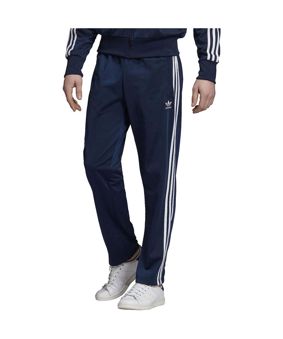 Adidas Mens Firebird Track Pants with an Elasticated waist and Ripped Cuffs along with a contrast 3 stripes Design on Legs, has a Regular Fit Size in Black colour, 100% Polyester Material.