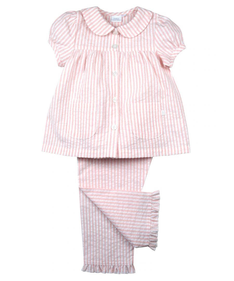 These smart summer pyjamas for girls are comprised of a pair of pale pink and white woven stripe short-sleeved top with long trousers with a frilled hem to match.  The top also features 2 handy pockets pocket, Peter Pan collar, engraved buttons and puff short sleeves. Made in a lightweight seersucker fabric that will keep them feeling fresh all summer long. Sure to become a new bedtime favourite, they're just the ticket for a good night's sleep!\n\nDesign & Fit\n\nClassic pink / white seersucker pyjamas\nShort-sleeve button through top\nPeter Pan Collar\nElasticated waistband\nEasy, pull-on style\nFabric and Care\n\n100% Cotton \nMachine wash\nSafety warning: keep away from fire
