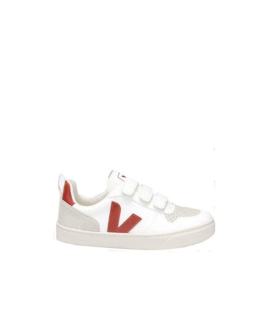 White leather trainers for girls by Veja. The upper has a red logo on both sides and red heel and toe panels made in suede. With a white velcro fastening and textile insole, these trainers also have an ivory non-slip rubber sole.