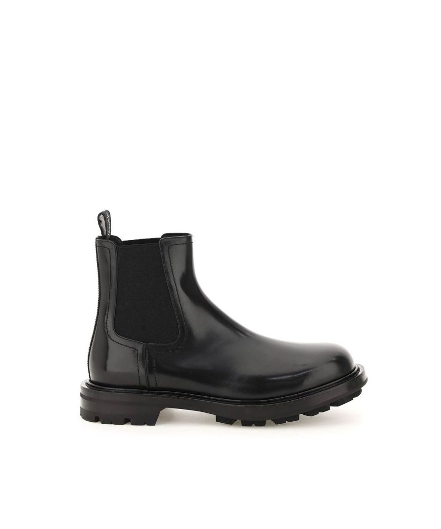 Alexander McQueen chelsea boots crafted in brushed calf leather with side elastic inserts and rear loop tab in branded ribbon. Leather lining, rubber sole with notched tread.