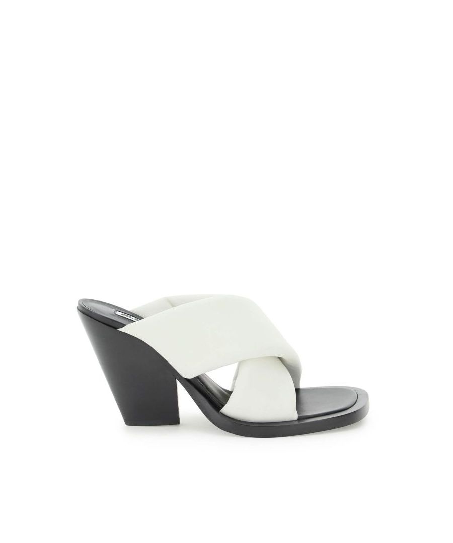 Jil Sander mules characterized by the two crossed bands crafted in padded nappa leather. Smooth leather insole, leather heel and sole with oversized rounded toe. 