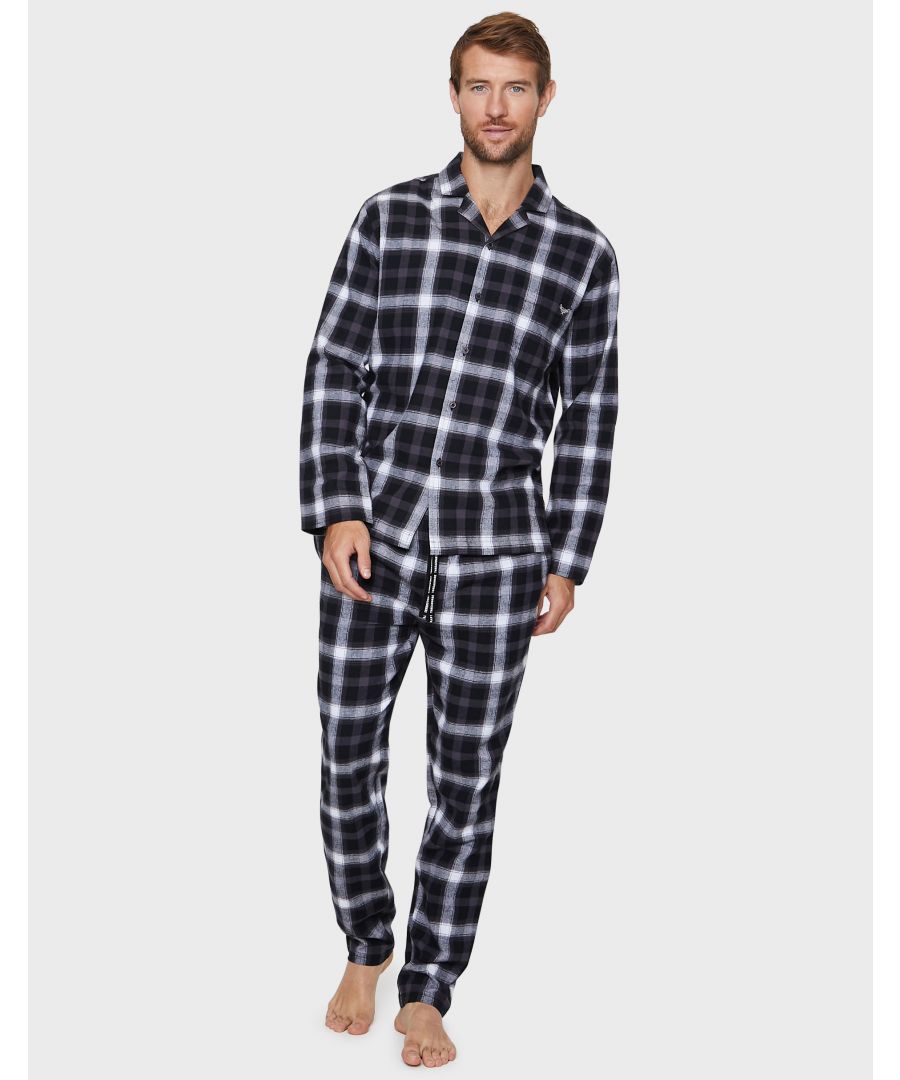 Bring a classic look to your loungewear with this check flannel button through pyjama set from Threadbare. Including a long sleeve shirt with collared neck and long bottoms with two side pockets and have an elasticated waistband with a drawstring for extra comfort. Made from a soft cotton fabric to ensure a comfortable feel and easy washing. This set is perfect for lounging at home or bedtime.