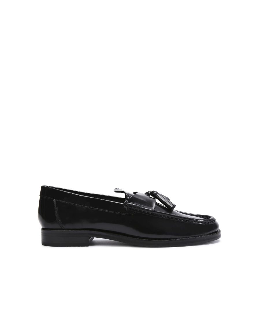 The Spencer is a formal slip-on shoe crafted from a shiny black leather. The vamp is topped with tassel detail.