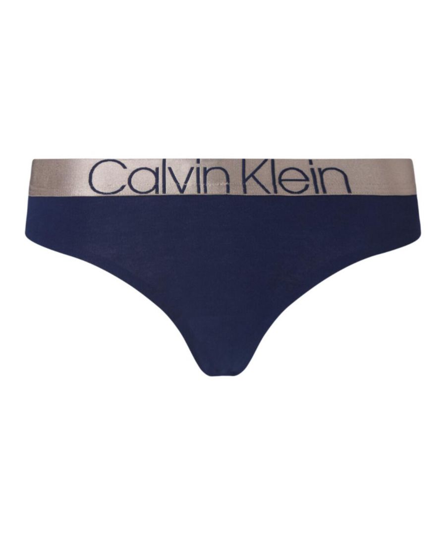 The Icon collection at Calvin Klein combines throwback 90's shapes with sleek, modern, metallic trims for standout, distinctive lingerie. This thong features the iconic Calvin Klein waistband in a shimmery new vibe. The brief is crafted from a stretch fabric with an elasticated waistband for a flexible and comfortable fit all-day.\n\nRetro and distinctive design\nCalvin Klein elastic waistband\nMinimal rear coverage\nMedium rise waist\nComposition: 92% Cotton | 8% Elastane\n\nListed in UK sizes