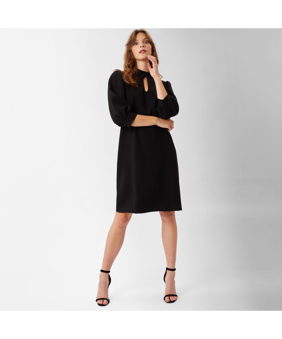Cut to a loose fit silhouette, featuring a high neck-line, key-hole opening and three quarter puff sleeves. Falls to the knee and fastens with a zip to the back.