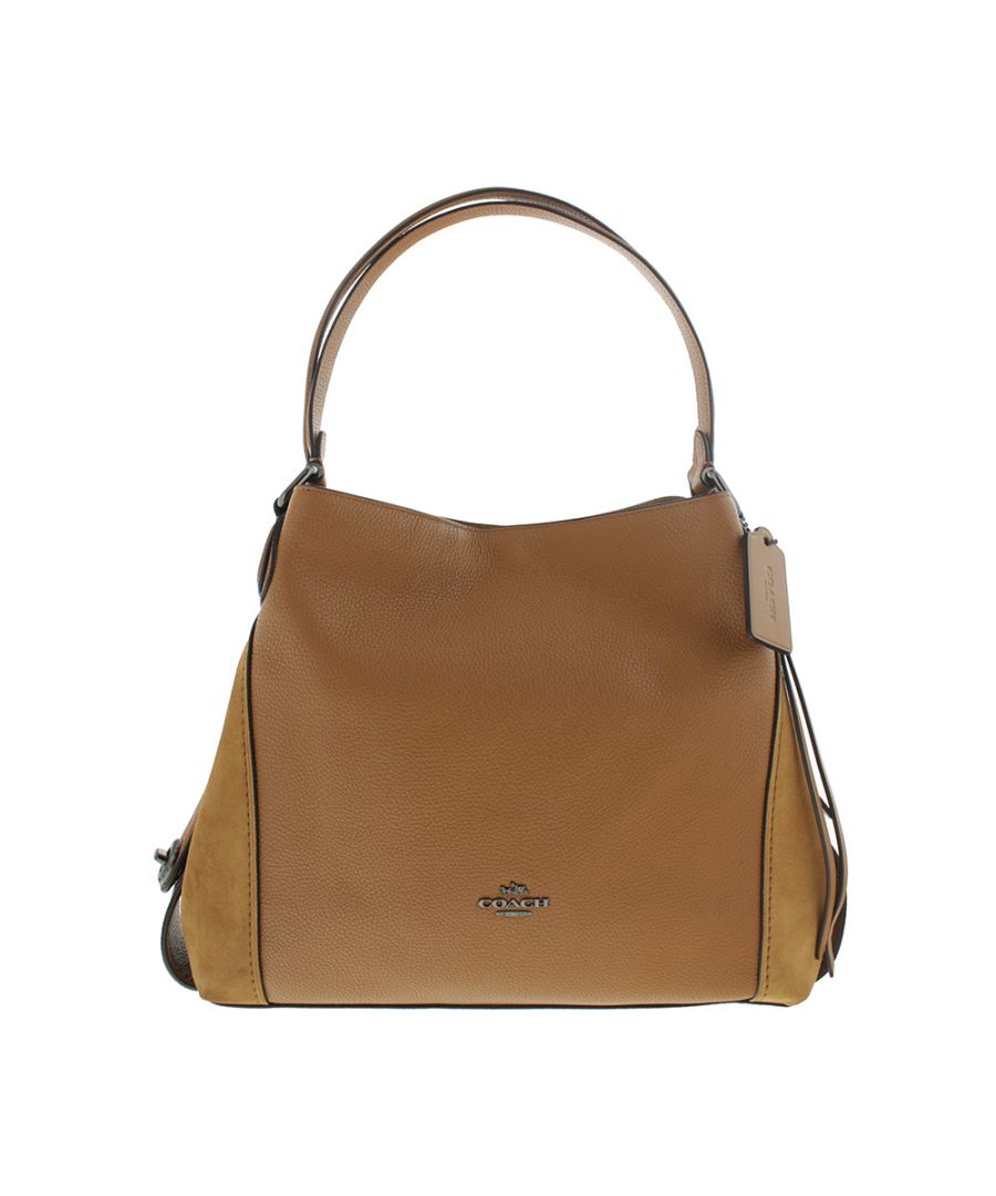 Coach Edie 31 Pebbled Leather Tan Shoulder Bag has been crafted from luxurious polished pebble leather. The main compartment has three fully lined sections the middle one is zipped, additionally there is a slip pocket for your mobile and a smaller zipped pocket for other personal items. Furnished with two handles and finished with a Coach luggage tag and Coach branding