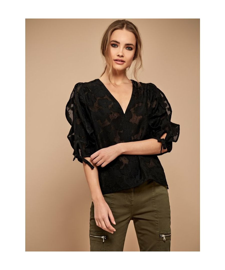 Designed in a textured burnout fabric, this white v-neck top features ruffle accents and tie detailing on its three quarter length sleeves. In an easy to wear relaxed fit, this top epitomises day to night style.