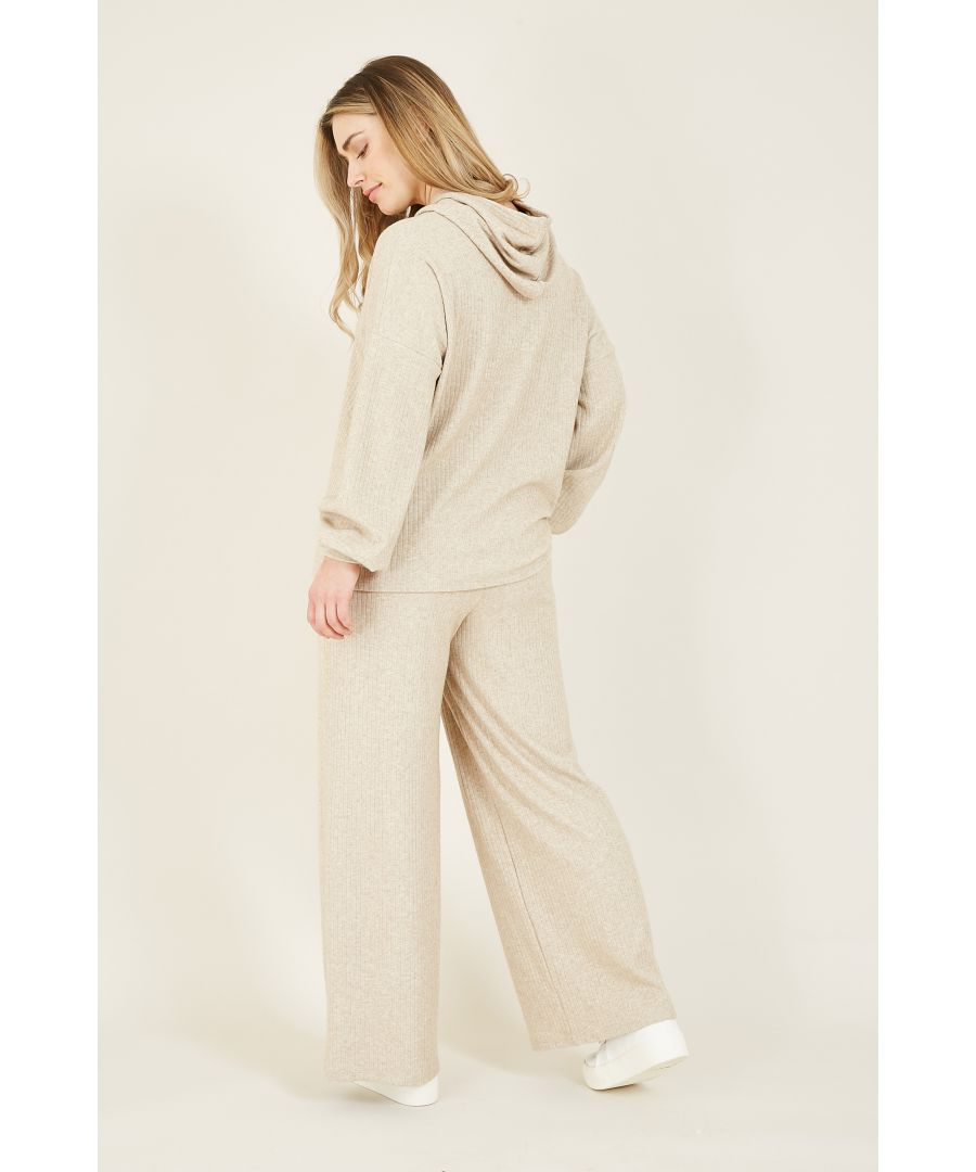 Upgrade your loungewear collection with our Yumi Brushed Ribbed Wide Leg Joggers. Cut to an ankle-grazing shape, it takes on a relaxed silhouette thanks to the wide leg design and fitted waistline. With a neutral tone running through the soft-touch, ribbed fabric, this pair of lounging trousers are a versatile piece to wear at home. Looking for the perfect matching piece? Choose a sweatshirt and knitted jumper to finish.  45%Viscose 26%Polyester 20%Polymade 9% Elastane Machine Wash At 30
