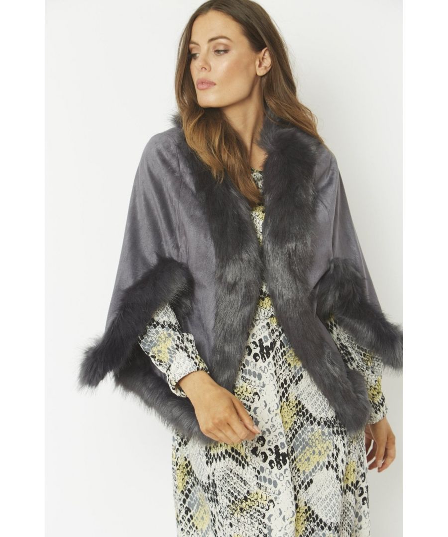 Immerse yourself in effortless luxury with this elegant, decadent faux suede cape with matching faux fur trim. Our luxurious cape can be worn to complete a modern layered look on those chilly days.