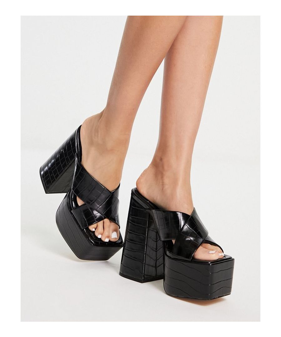 Mules by Topshop Hit new heights Slip-on style Crossover straps Open, square toe Platform sole High block heel Sold by Asos