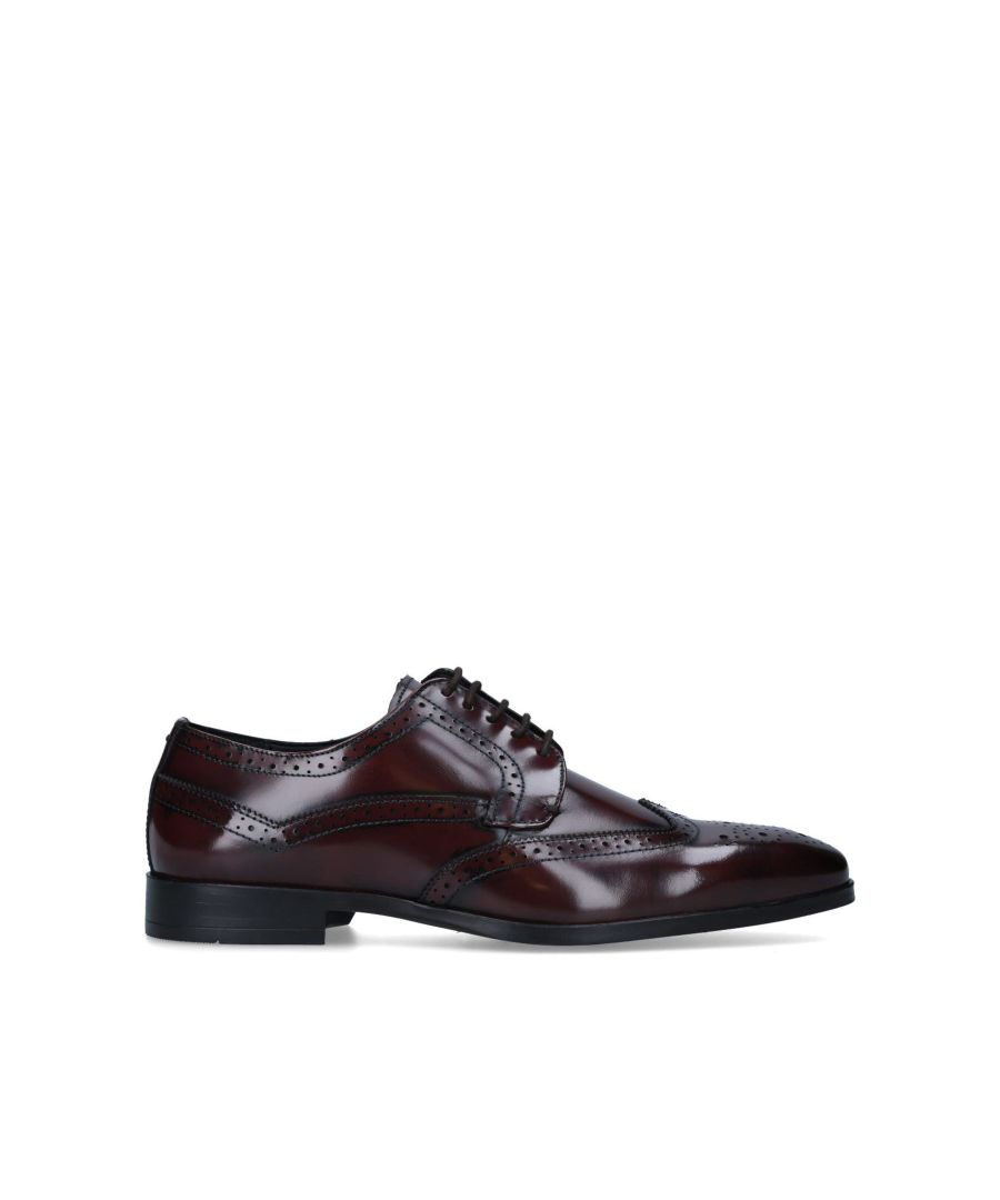 The Chester shoes are a formal leather brogue shoe. The lace-up upper is in a formal wine shade with complete stitching and wingtip detail on the top. The black sole sits on a small block heel.