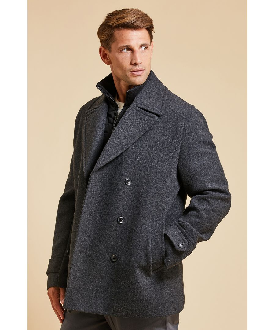 Add a level of sophistication to your wardrobe this season with this coat from Threadbare’s new ‘Luxe’ collection. This tailored coat is in a double-breasted design and features a button fastening, revere collar, two front pockets and a button cuff detail. This coat also features a zip up funnel necked mock layer that provides both warmth and practicality on those colder days. Layer this regular fit coat over a shirt and smart trousers or jeans for that stylish look.