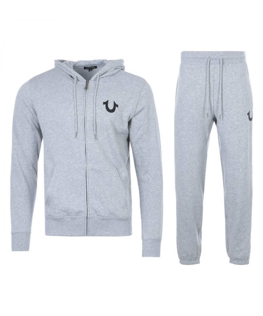 The Lullaby Hooded Sweatshirt Tracksuit Set from True Religion boasts their bold designs with supreme comfort. Both pieces have been crafted from a soft cotton blend providing comfort and breathability. The joggers are fitted with a drawstring waist and elasticated cuffs, whilst the hoodie is fitted with a drawstring hood, split kangaroo pocket and a full zip closure. Both finished with iconic True Religion branding.Regular Fit, Cotton Blend Composition, Zip Up Hooded Sweatshirt, Drawstring Joggers, True Religion Branding. Style & Fit:Regular Fit, Fits True to Size. Composition & Care: 60% Cotton, 40% Polyester, Machine Wash.